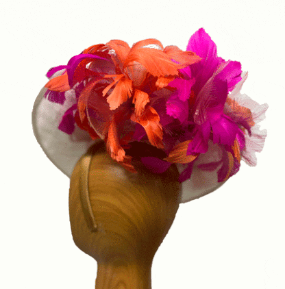 Ivory fascinator with orange and fuchsia feathers