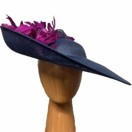 Navy blue fascinator hat with deep magenta feathers