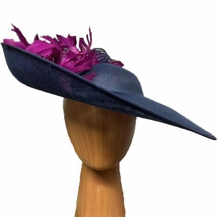 Navy blue fascinator hat with deep magenta feathers