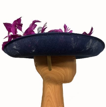 Navy blue fascinator hat with deep magenta feathers