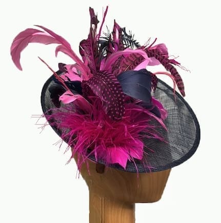 navy blue fascinator with multiple pink fuchsia feathers