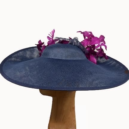 Navy blue fascinator hat with deep magenta feathers