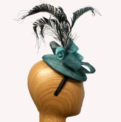 small teal fascinator with peacock feathers