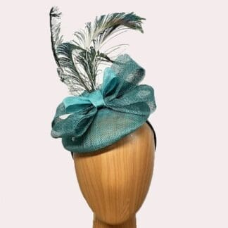 small teal fascinator with peacock feathers