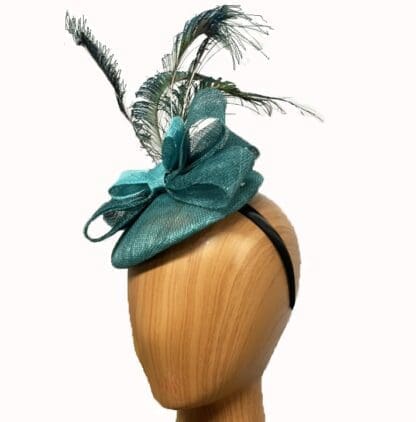 small teal fascinator with peacock feathers